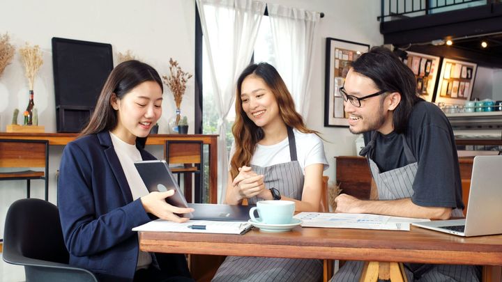 couple restaurant owners talking with agent
