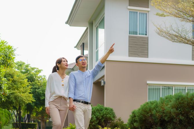 happy couple outside their house