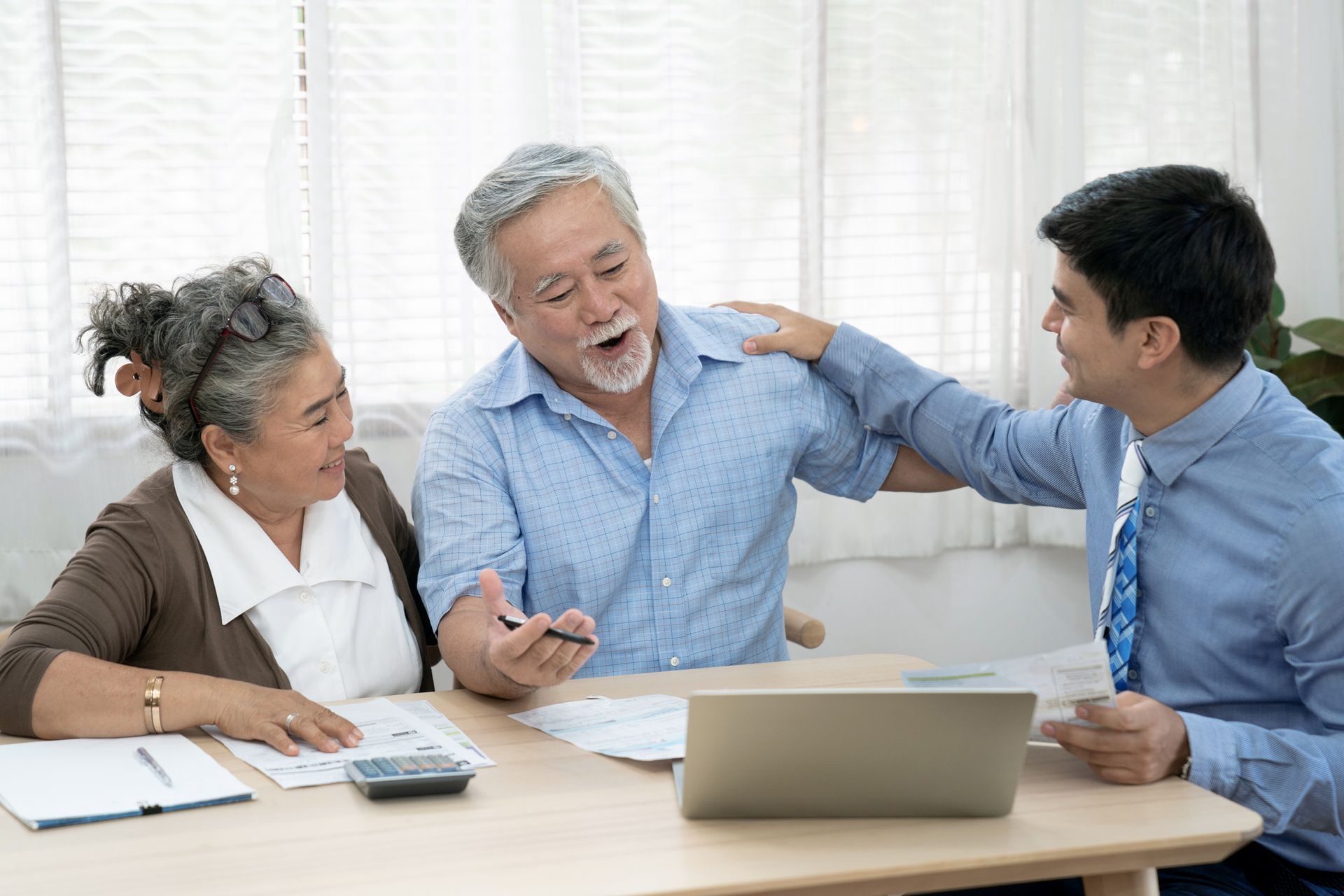 happy elderly couple with agent