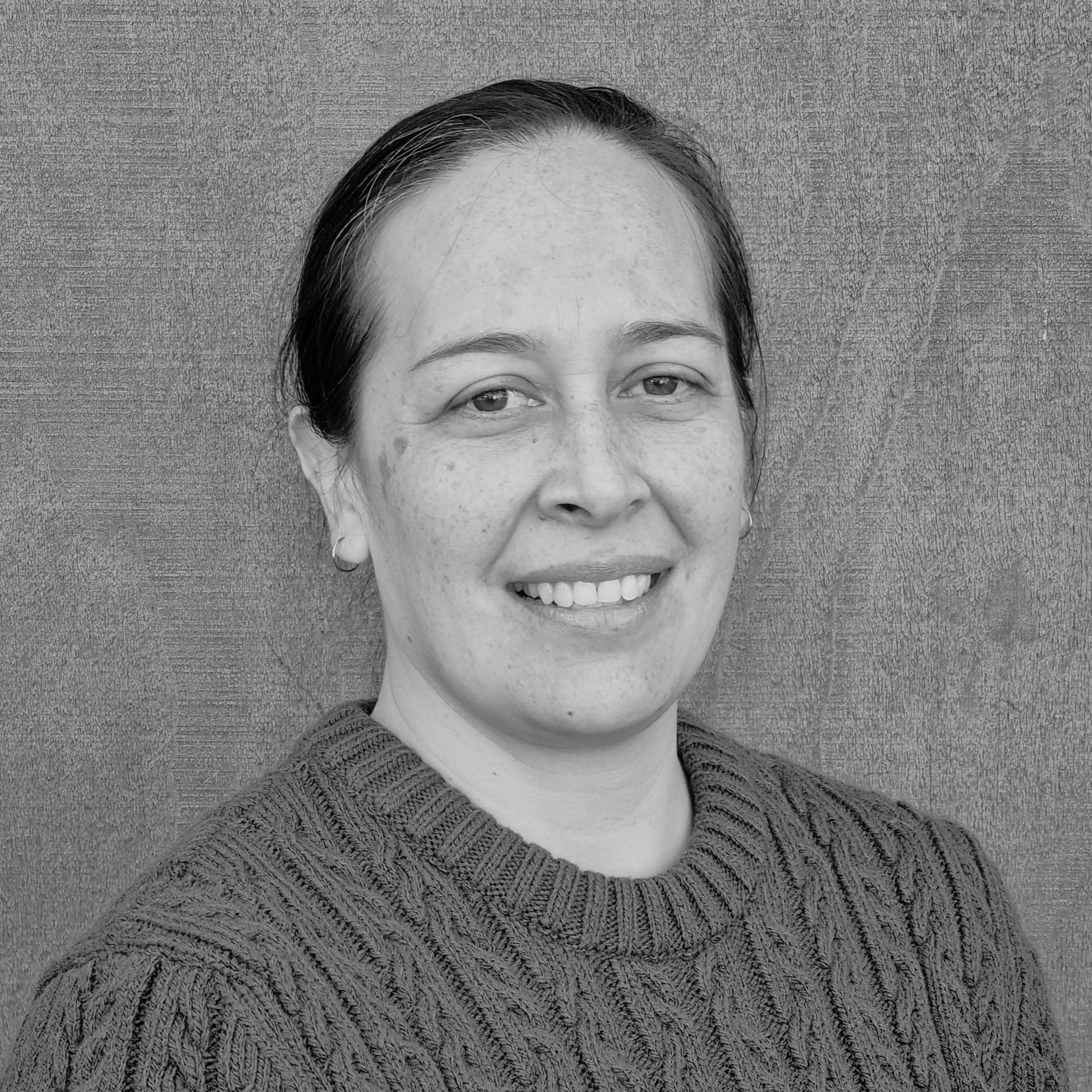A black and white photo of a woman wearing a shirt that says the centre for health.
