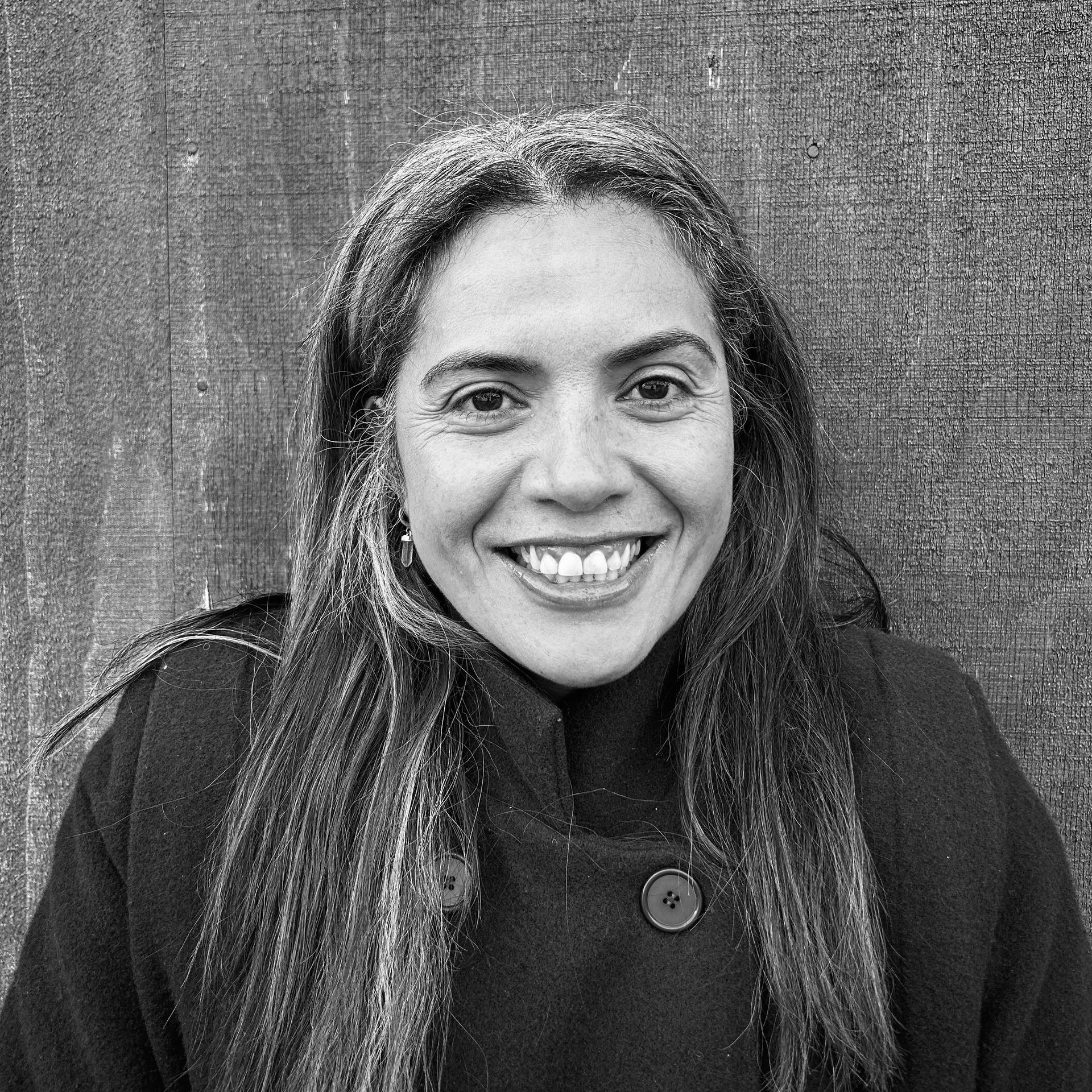 A black and white photo of a woman smiling in a circle.