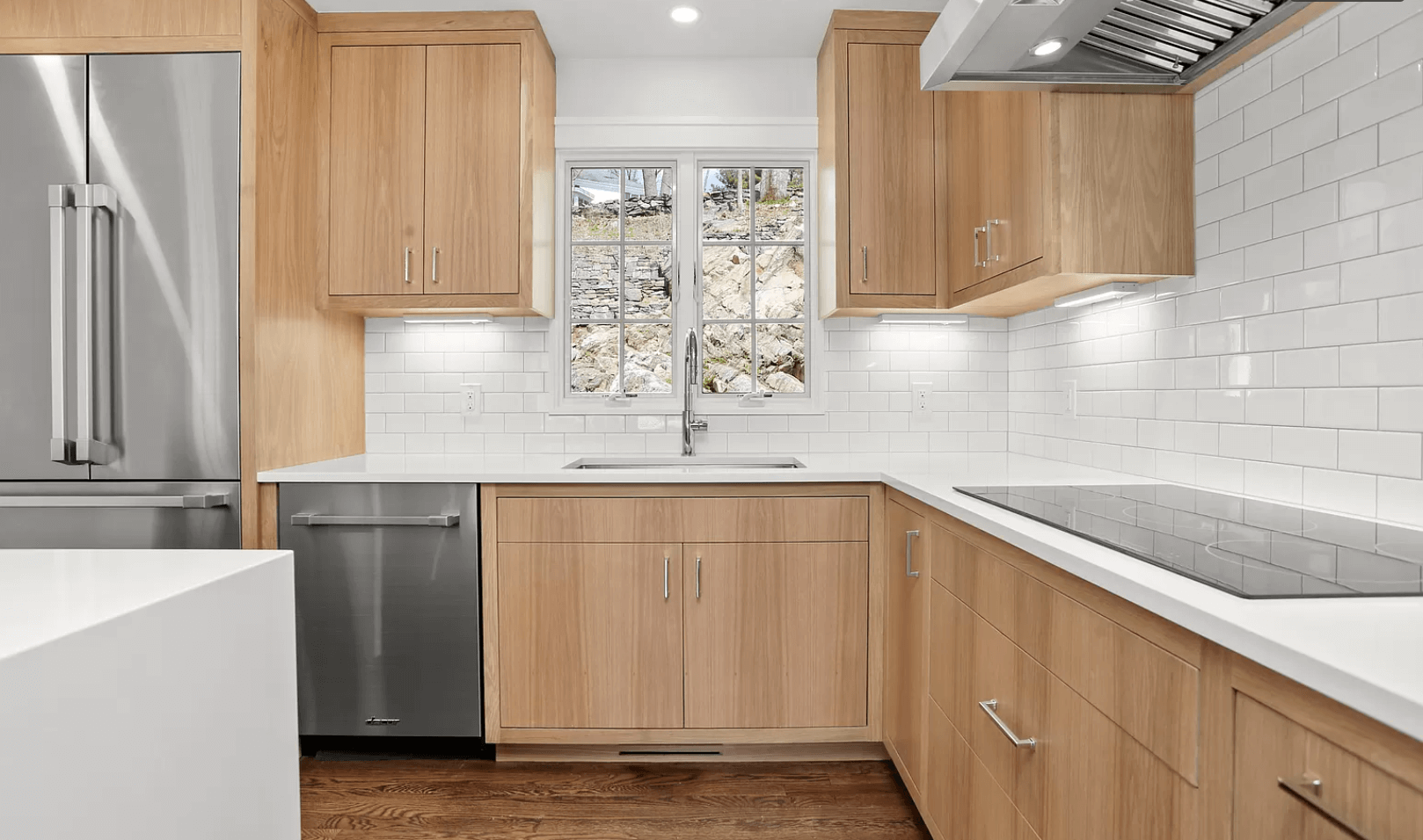 A kitchen with wooden cabinets and stainless steel appliances.