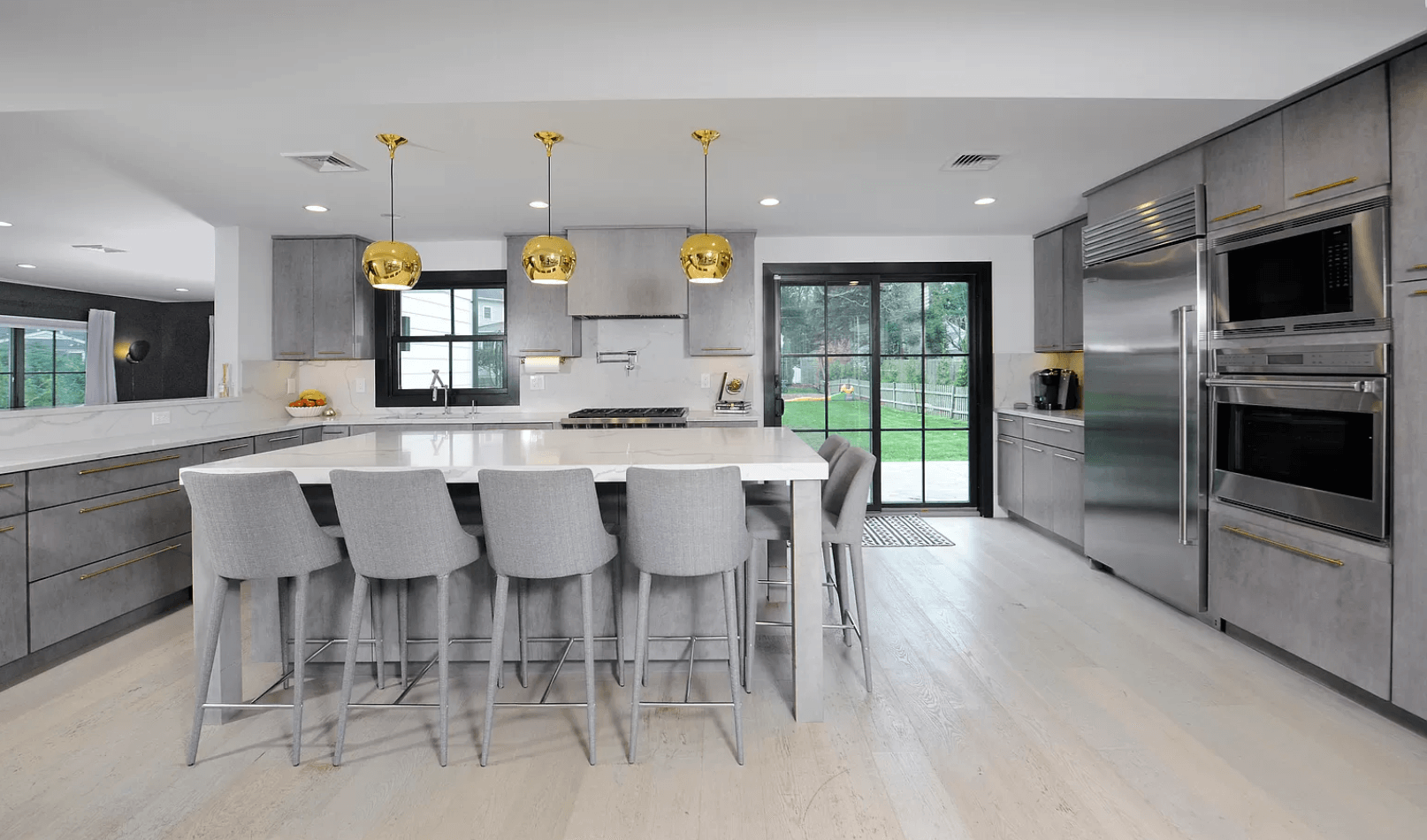 A kitchen with stainless steel appliances and a large island