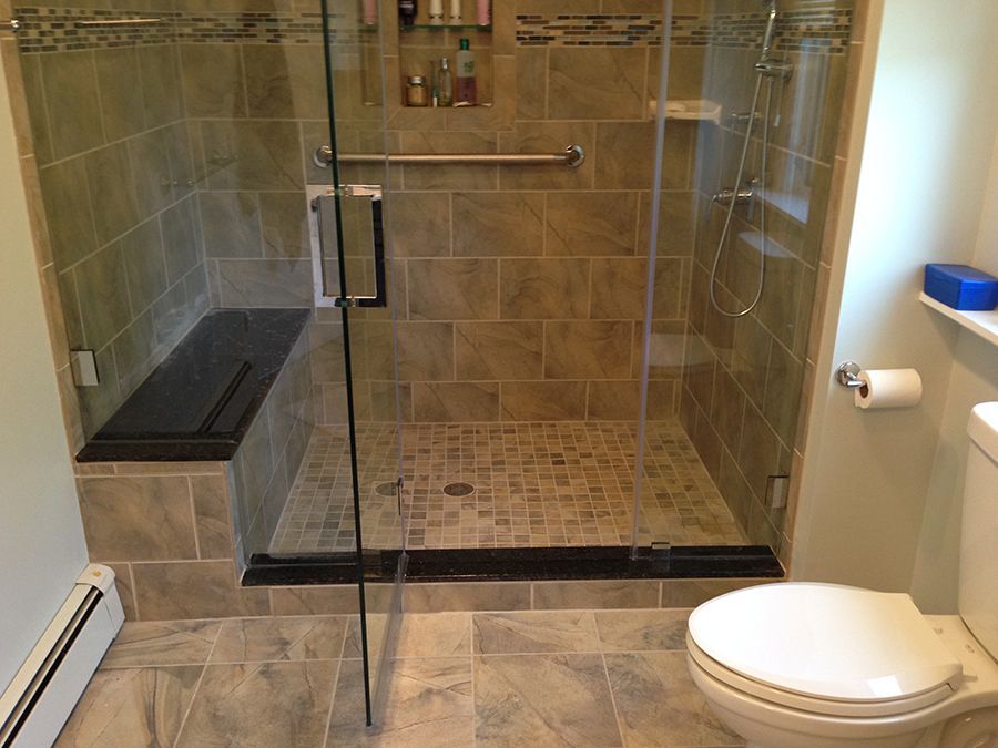 A bathroom with a walk in shower and a toilet