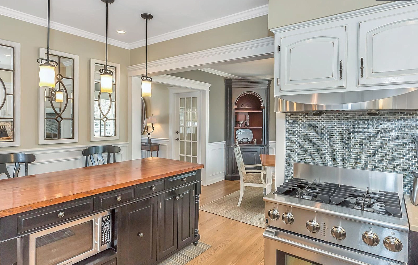 A kitchen with stainless steel appliances and a large island.