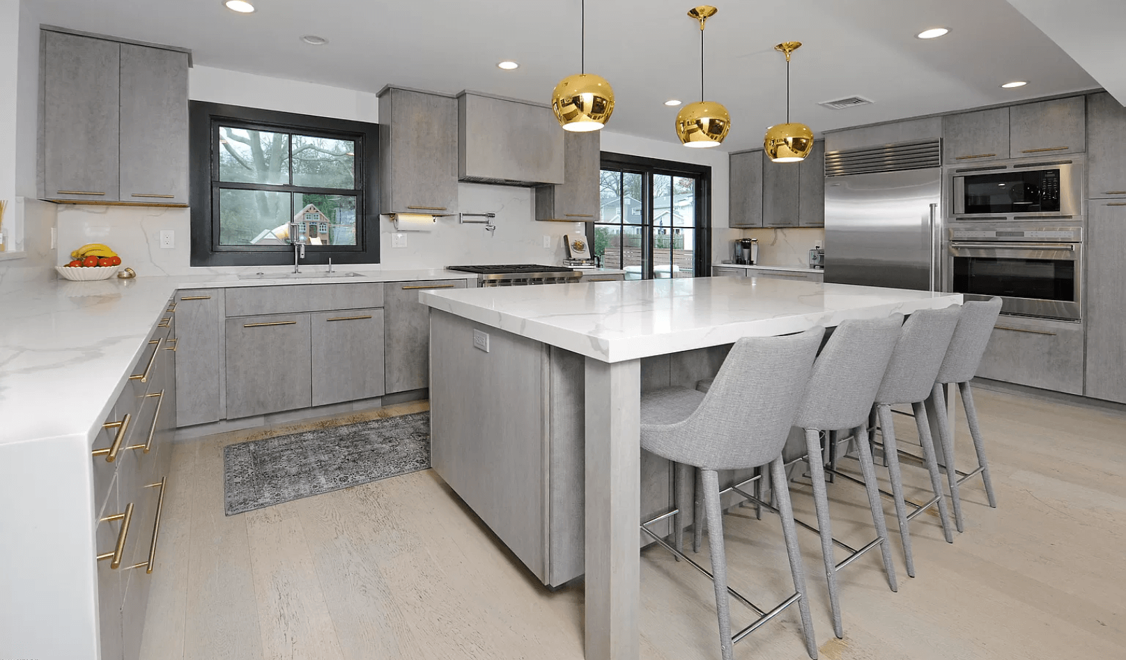 A kitchen with a large island and stools