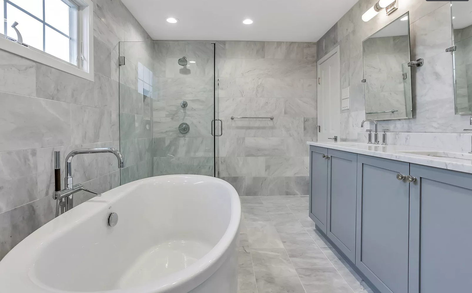 A bathroom with a bathtub , sink , and shower.