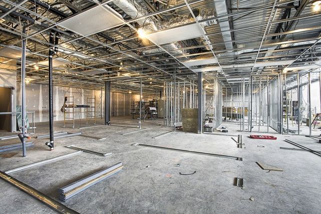 A large empty room with a ceiling that is being built.