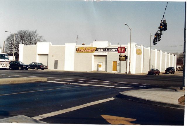 A white building with a sign that says