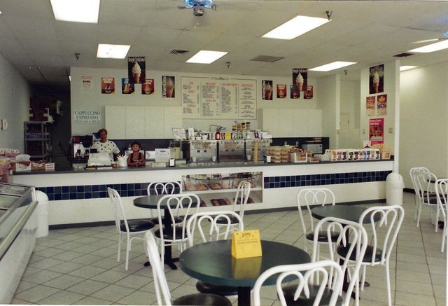The inside of a restaurant with tables and chairs
