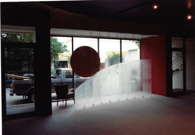 An empty room with a truck parked in the background