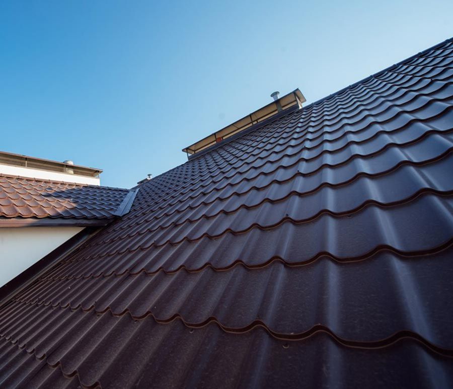A brown roof with a blue sky in the background