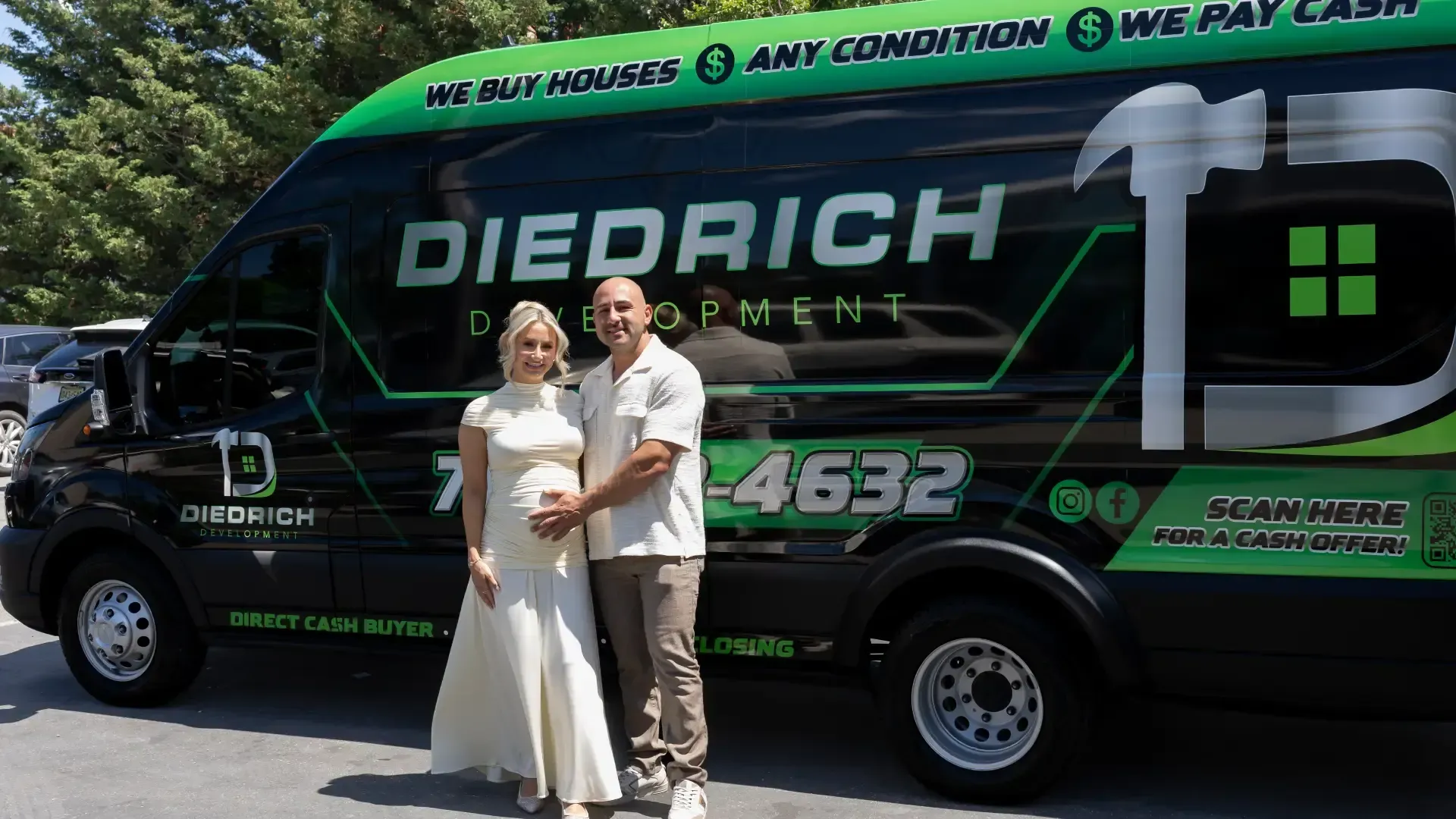 Two people standing in front of a green Diedrich service van in bright sunlight
