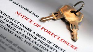notice of foreclosure document with 2 keys sitting on top