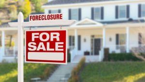 Foreclosure, for sale sign in front of house