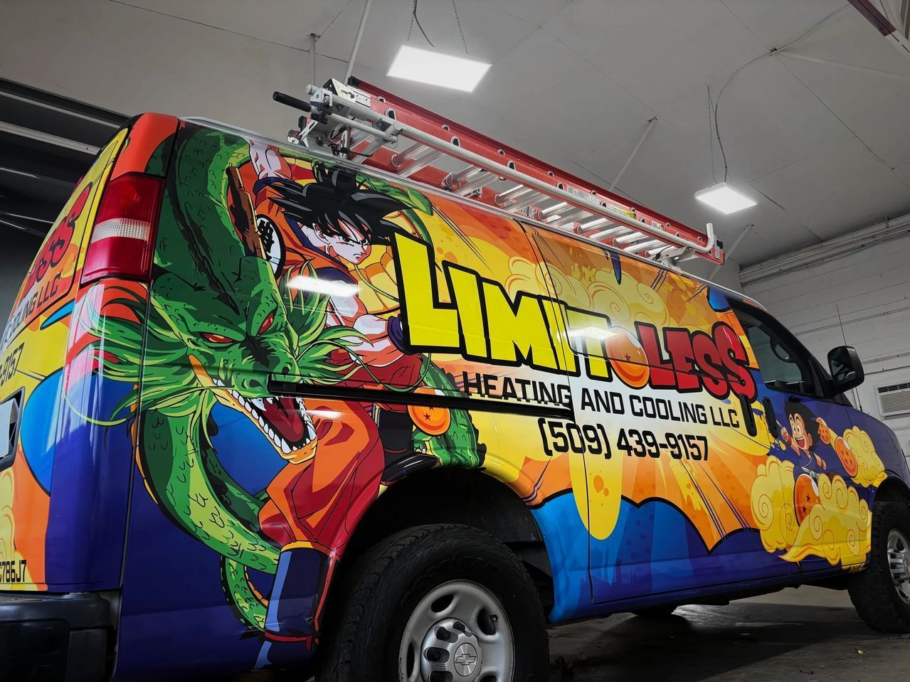 Colorful branded van with large “Lima” text and tropical graphics inside a garage.