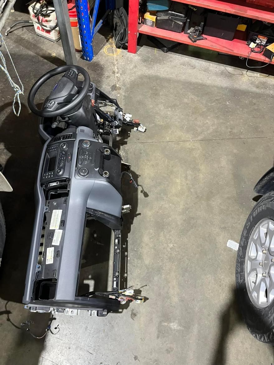 The Dashboard of a Car is Sitting on the Floor in a Garage — BA Auto Electrical In West Mackay, QLD