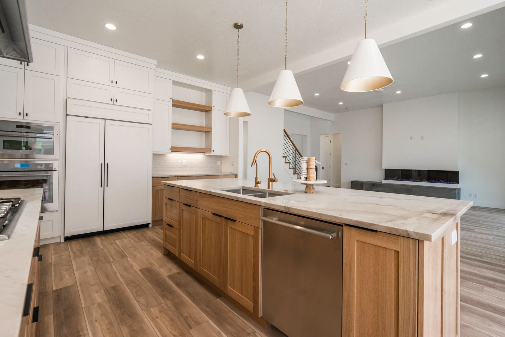 A kitchen with stainless steel appliances and wooden cabinets.