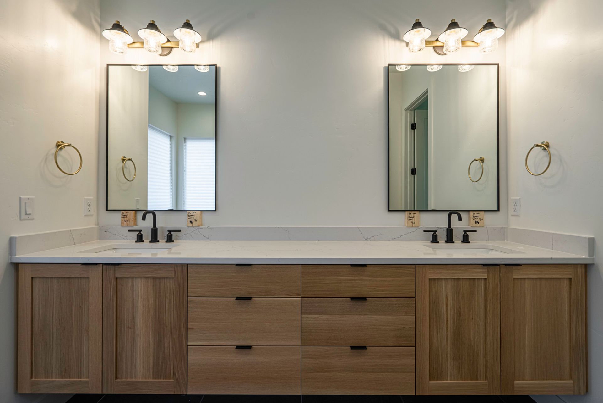 A bathroom with two sinks and two mirrors.