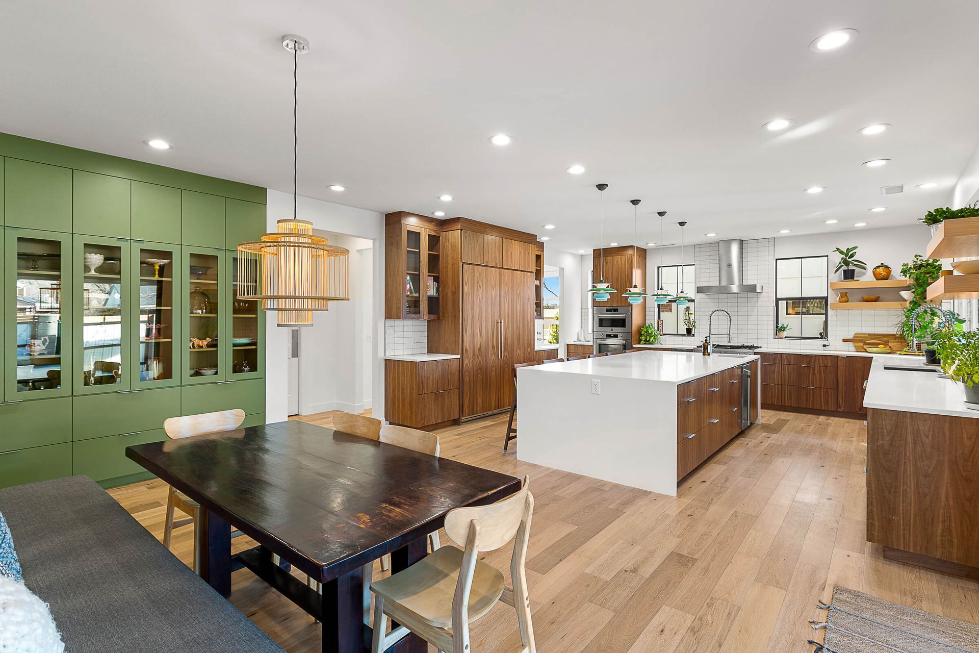 A large kitchen with a table and chairs in it.