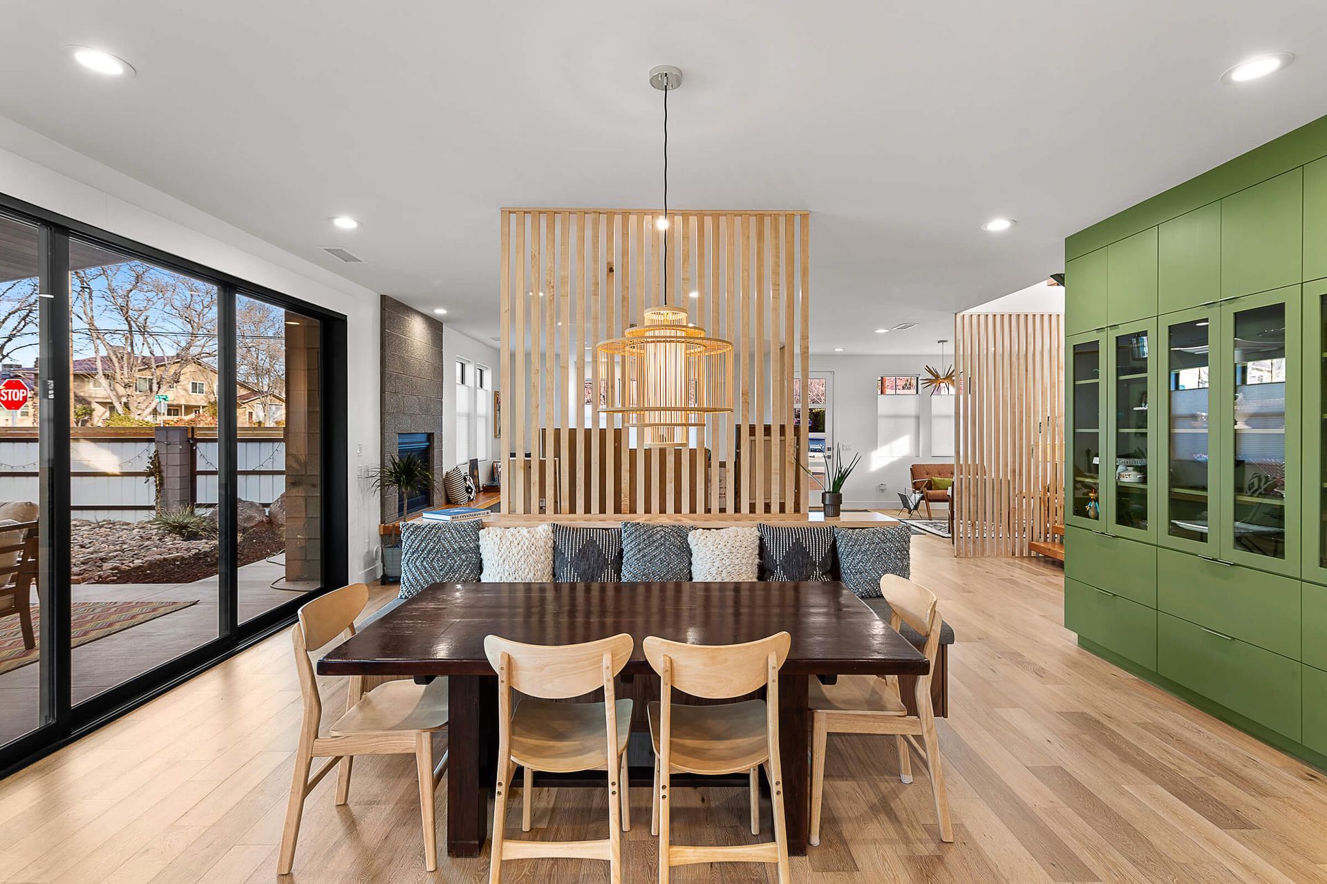 A large dining room with a wooden table and chairs.