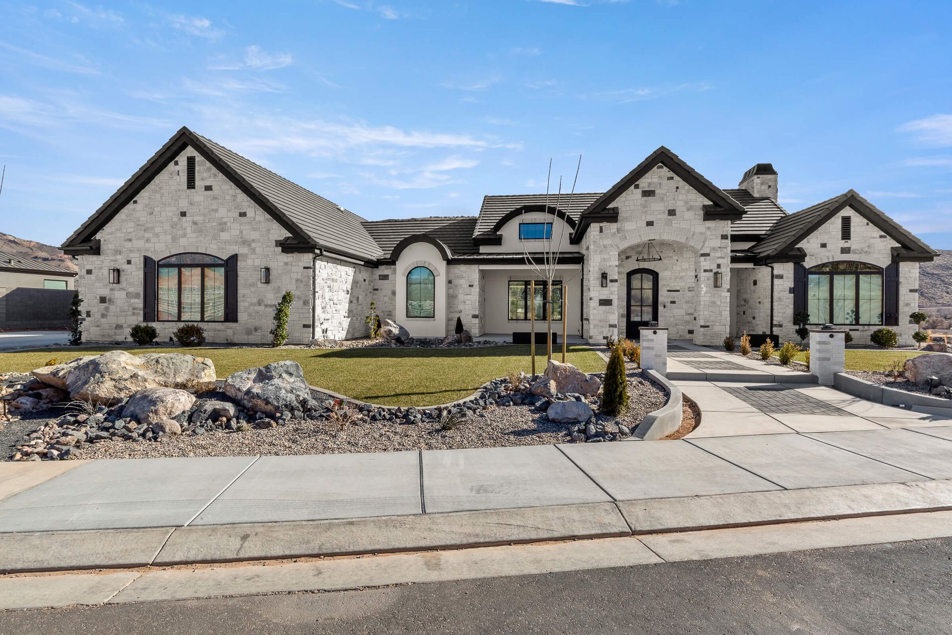 A large brick house with a lot of windows is for sale.
