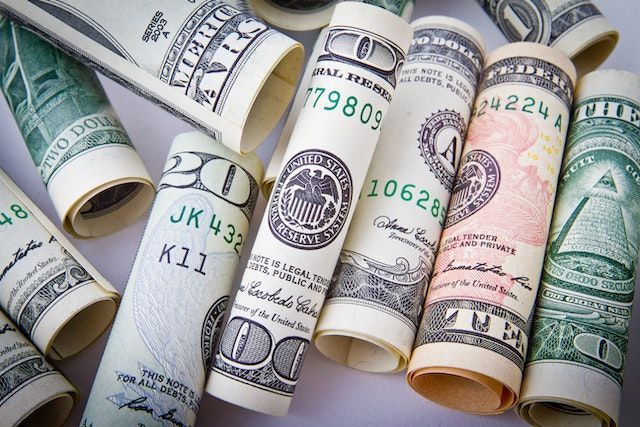a bunch of rolls of twenty dollar bills