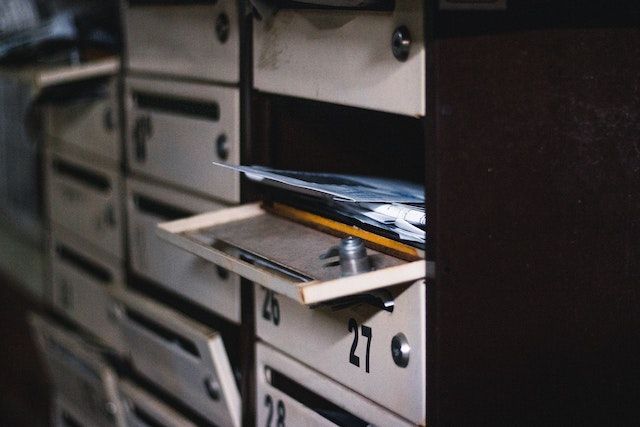 open city mailbox with a stack of letters inside