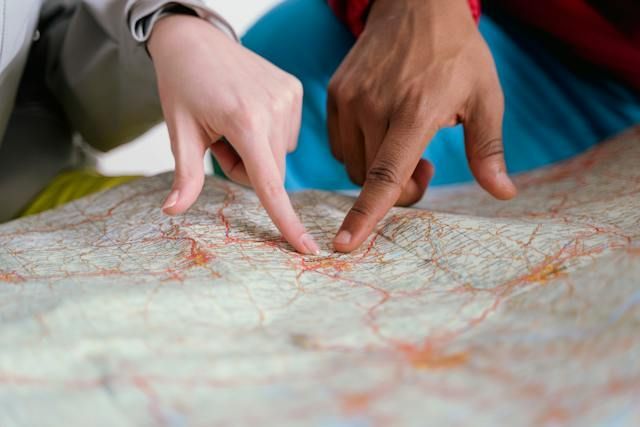 people-pointing-fingers-on-a-map