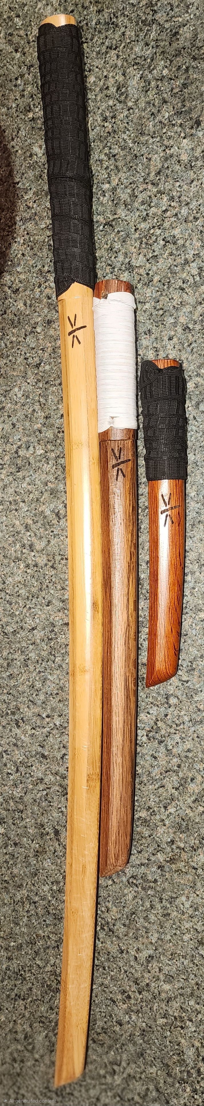 Several wooden-handled tools with dark metal heads leaning against a wall.