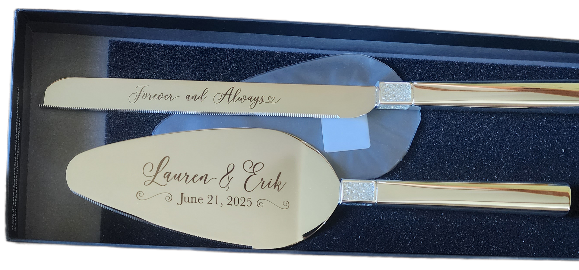 Engraved wedding cake server set in black box, silver handles with personalized names and date.