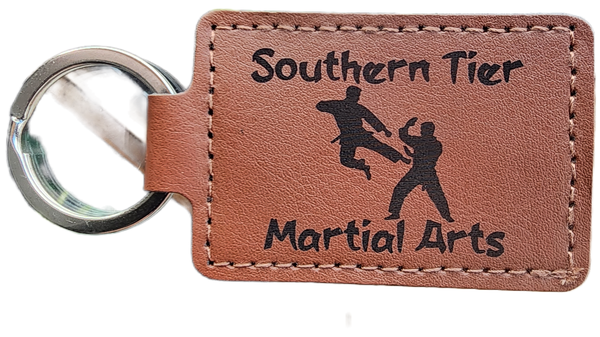 Brown leather keychain tag with ring, printed “Southern Tier Martial Arts” and two martial arts figures