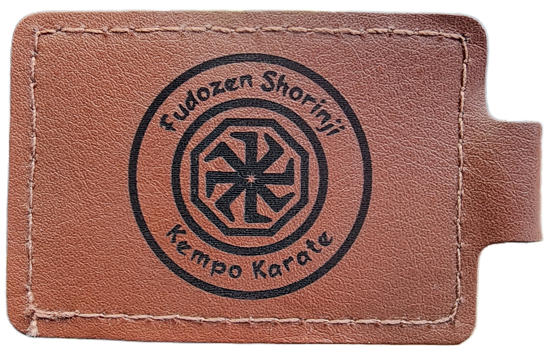 Brown leather patch with black circular Kenpo Karate logo and text stitched on it