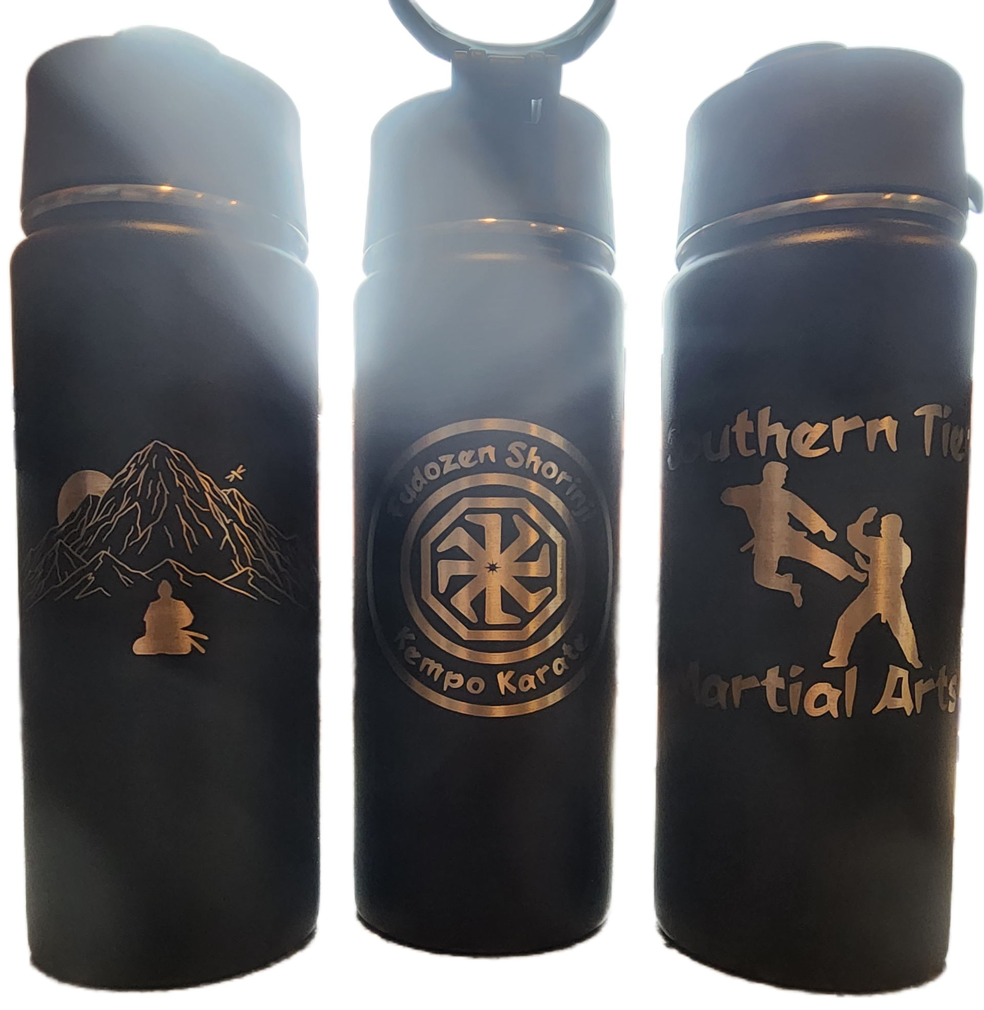Three black insulated bottles with gold designs and text, standing side by side on a white background