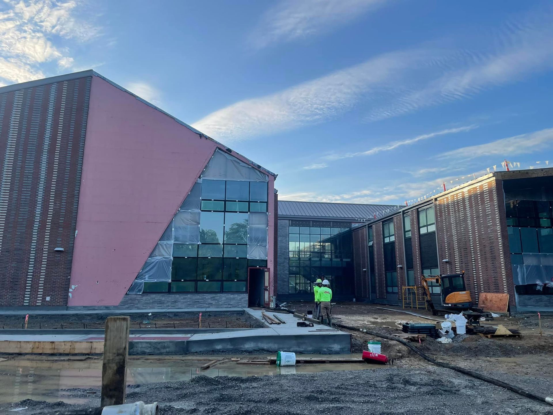 A large building under construction with a blue sky in the background.