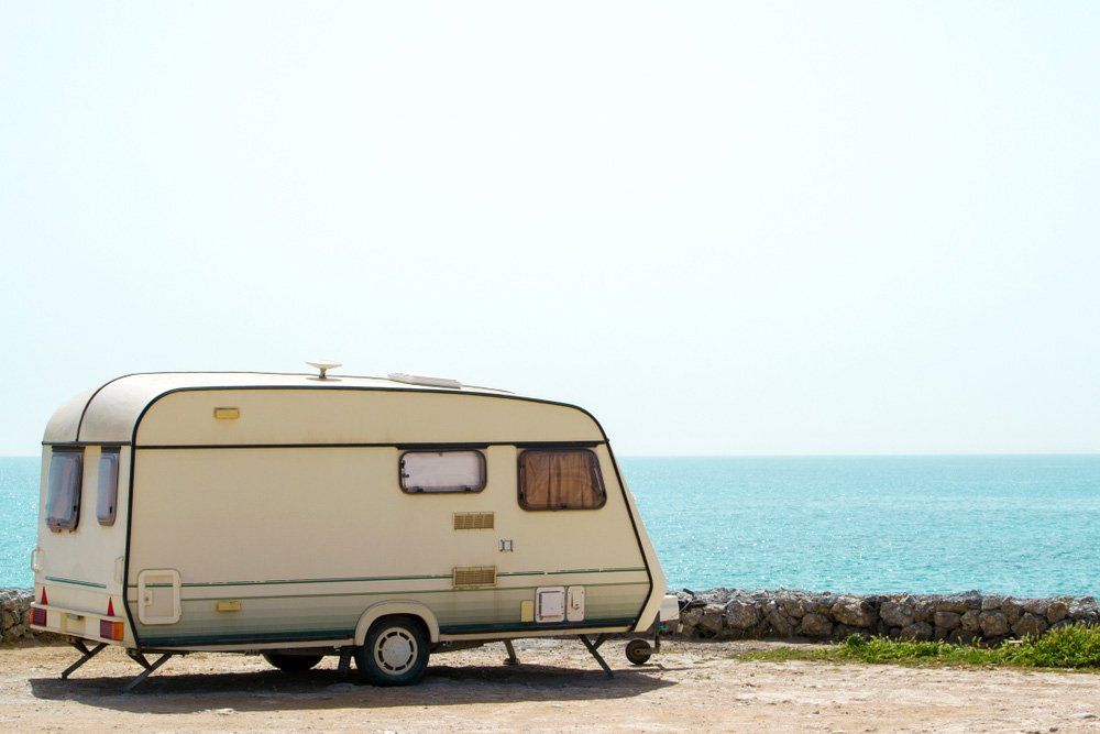 Old retro caravan staying on a beautiful  — Illawarra Car Service Centre In Oak Flats NSW