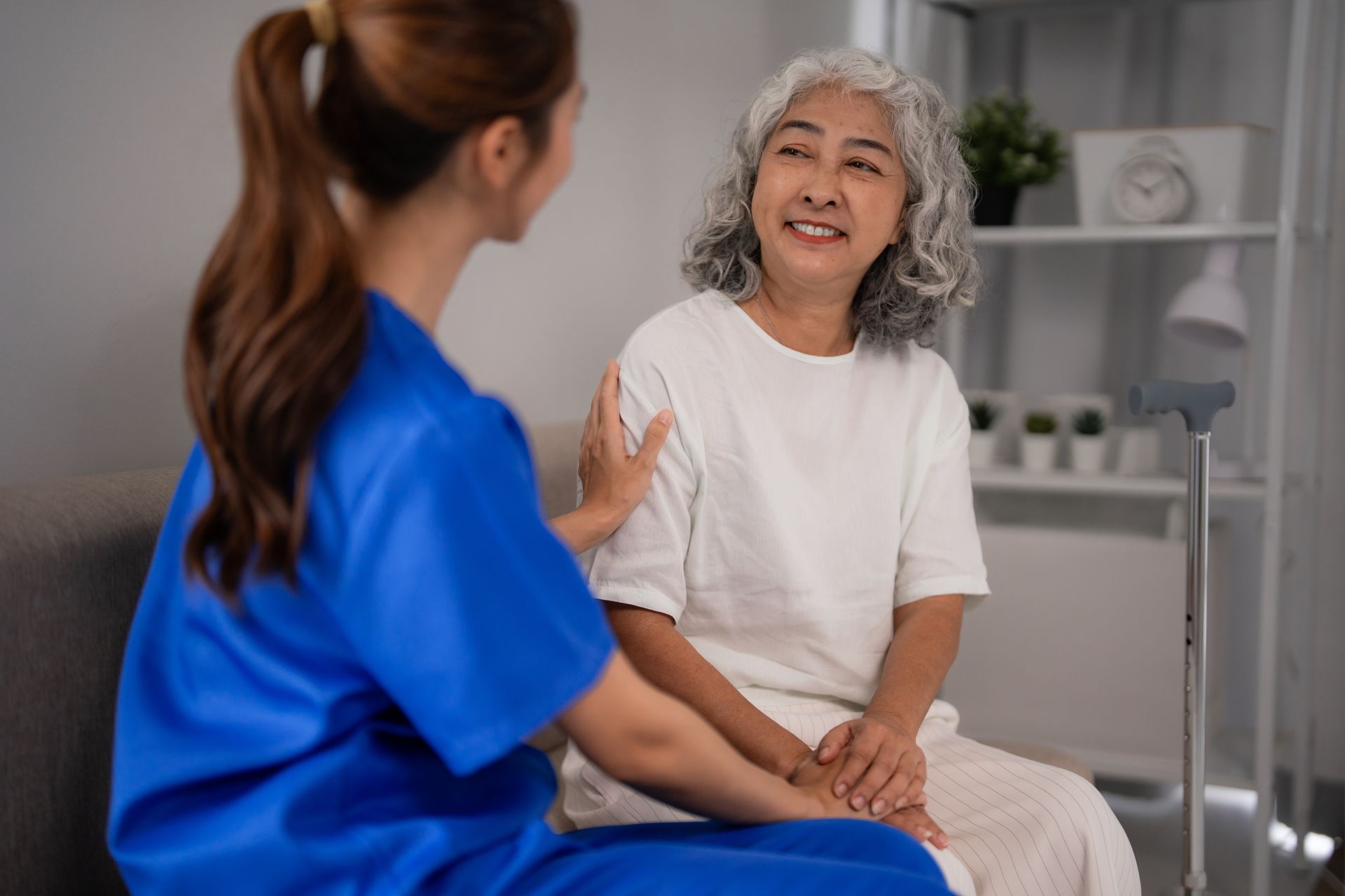 Caregiver sitting beside a senior woman at home, reflecting the trust long term home caregivers. Caregiver sitting beside a senior woman at home, reflecting the trust long term home caregivers.