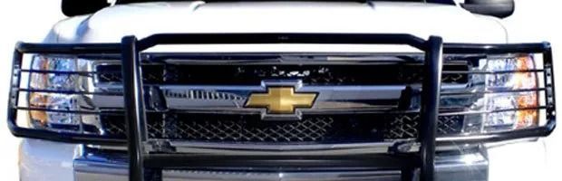 Front view of a white Chevrolet truck with a black grille guard and gold bowtie emblem