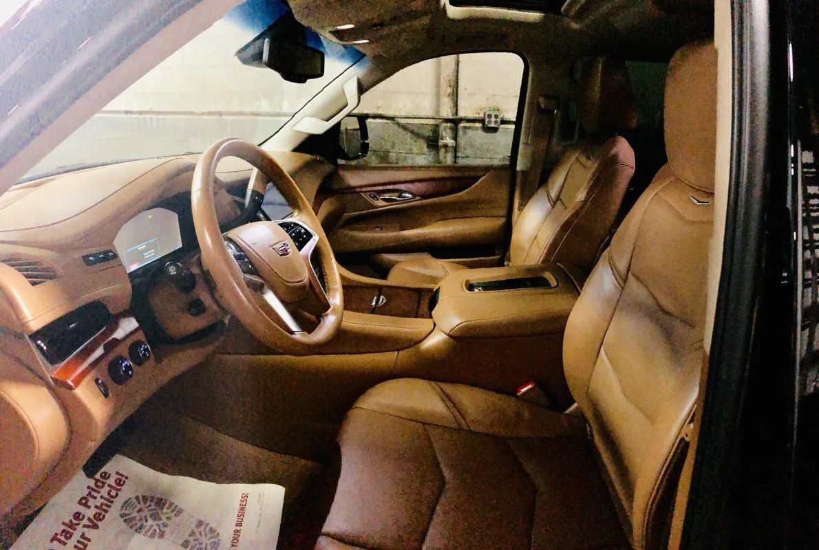 Tan leather car interior with steering wheel, front seats, and center console visible