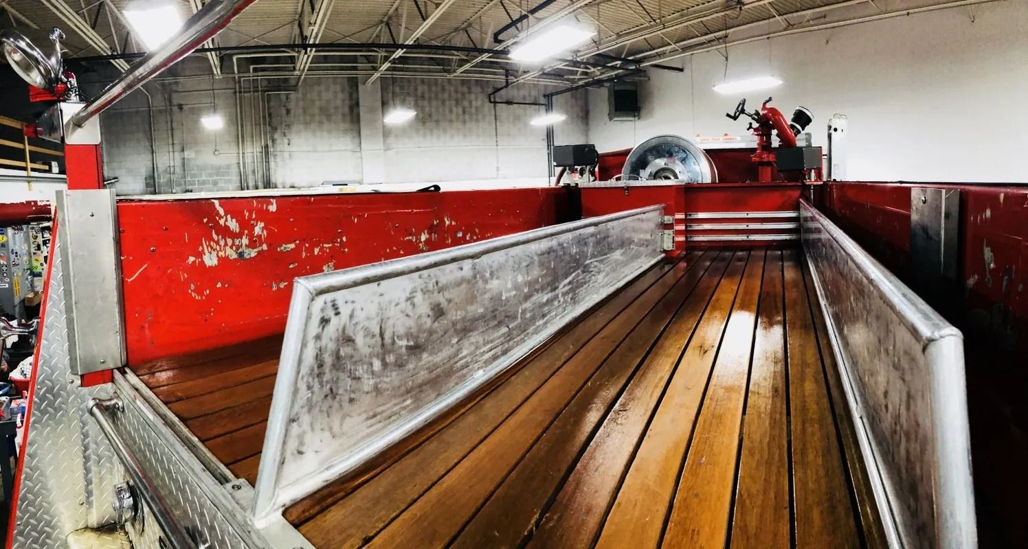 Wooden sled track with red walls inside an indoor winter sports facility
