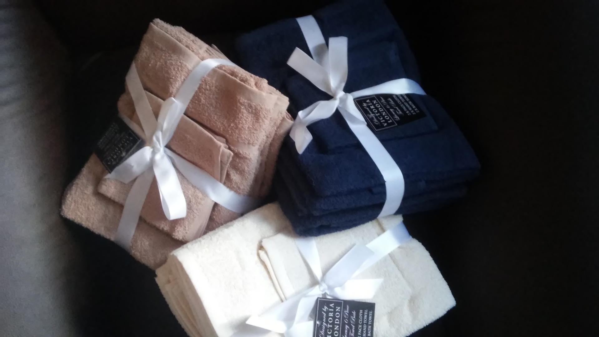 Three stacks of towels tied with white ribbons