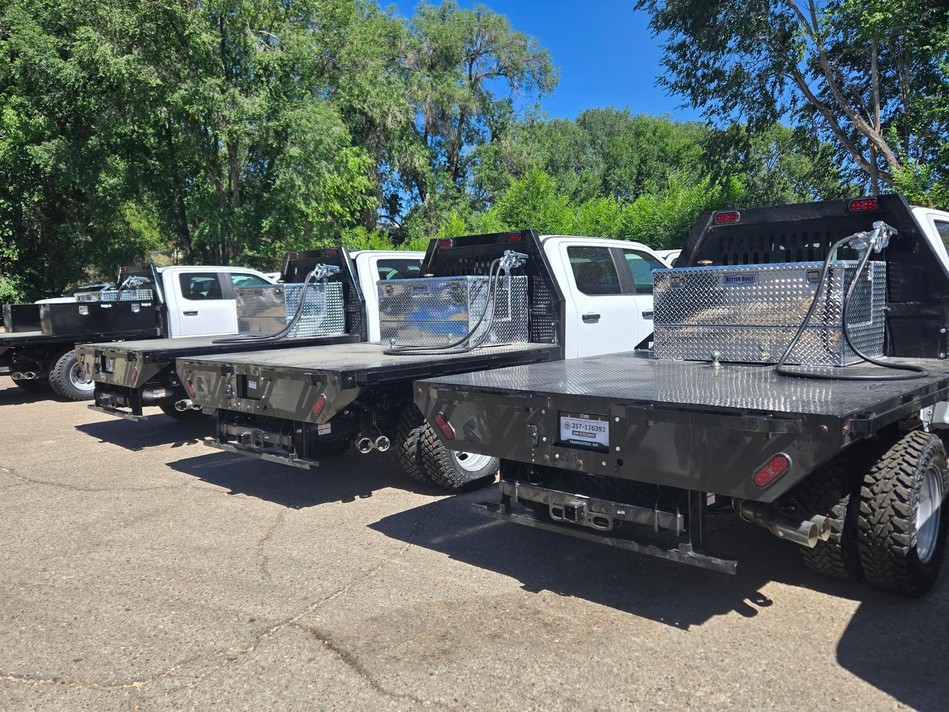 The back of a truck with a compressor on the bed.