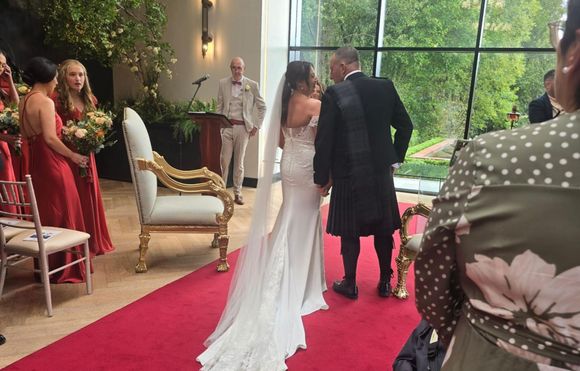 A bride and groom are walking down the aisle at a wedding ceremony.