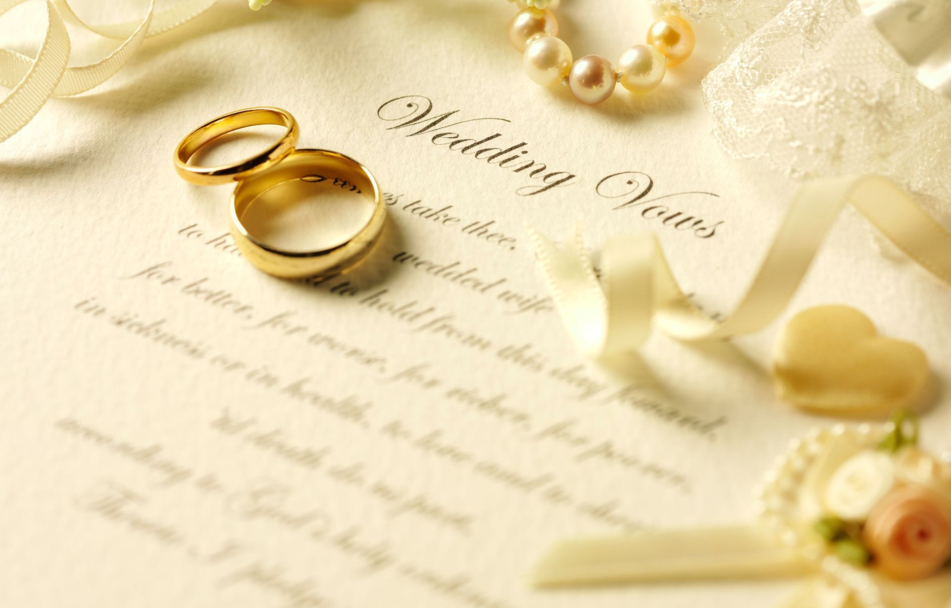 Wedding vows with two wedding rings and a pearl necklace