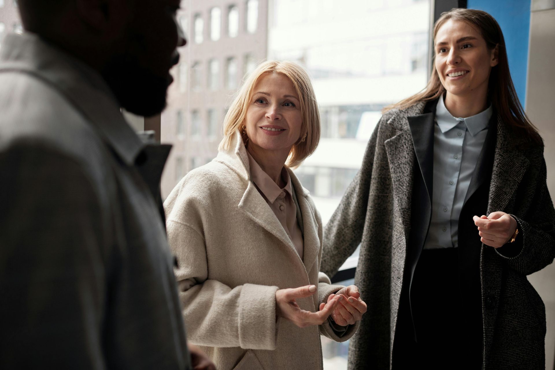 A group of people are standing next to each other and talking.