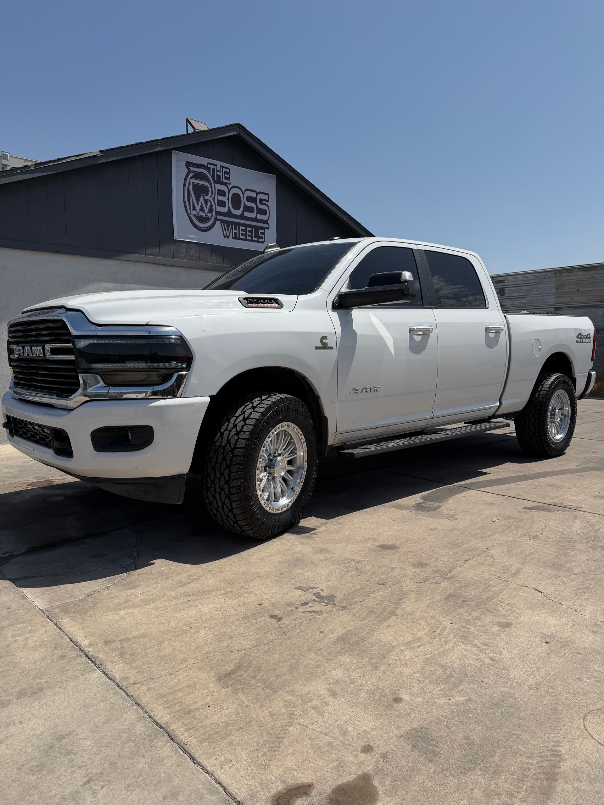 White pickup truck parked outside a building on a sunny day