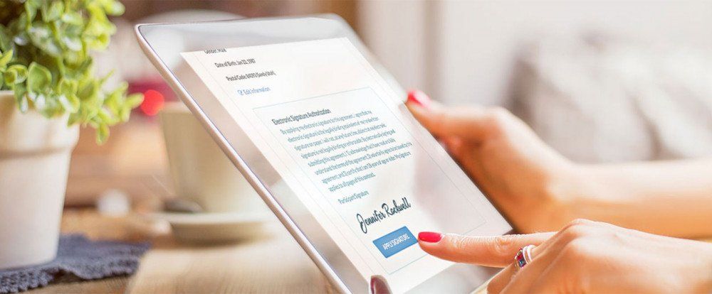 Woman applying signature on a tablet