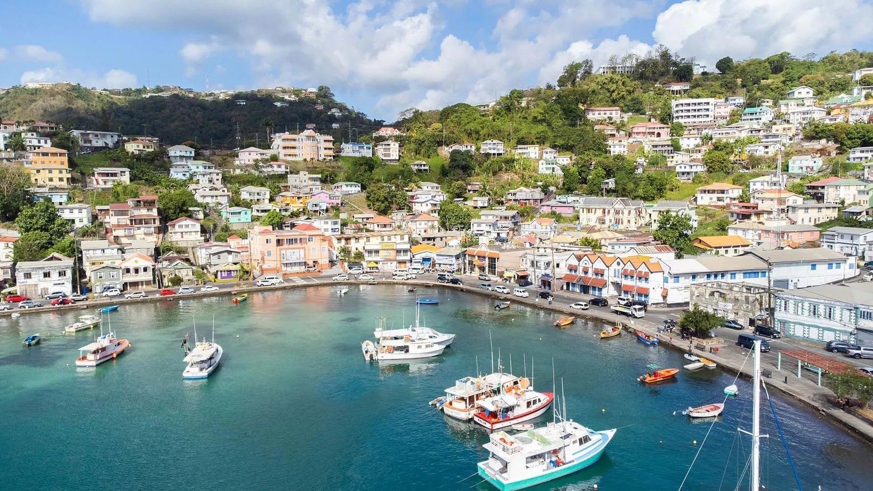 An aerial view of a harbor with boats in a city