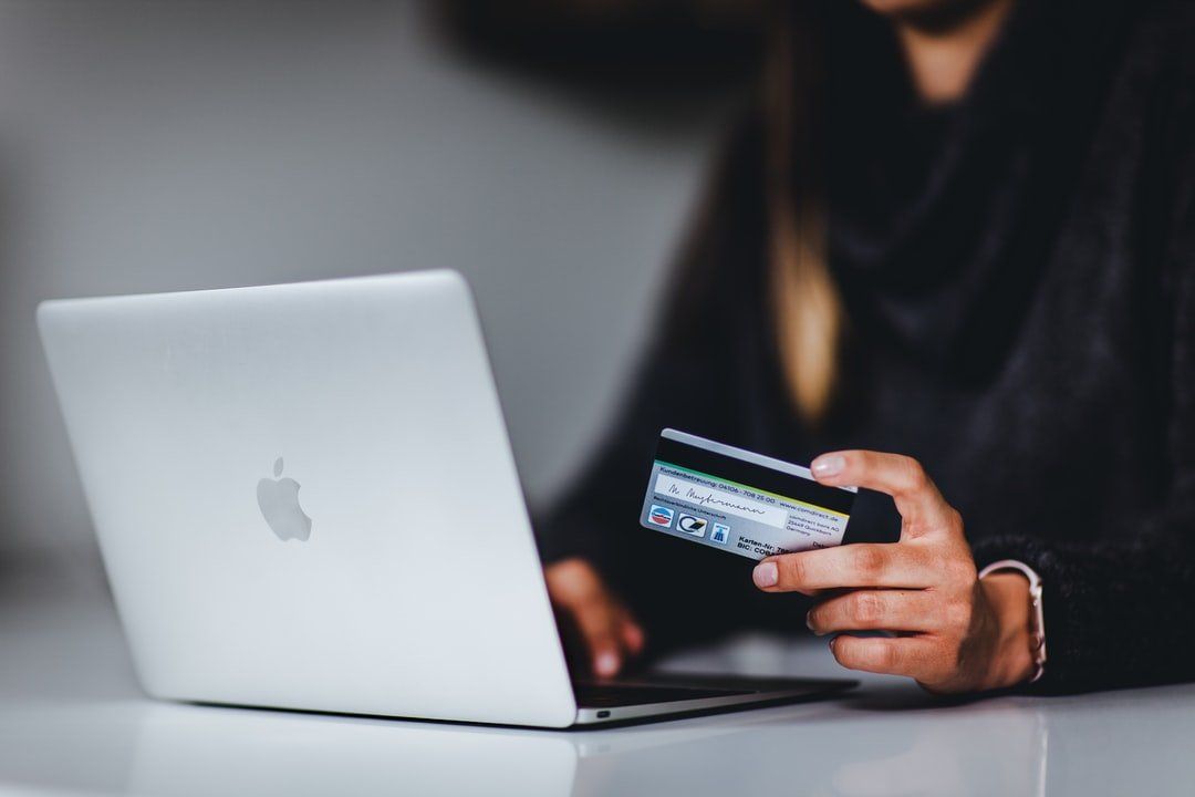 Person entering credit card info into computer