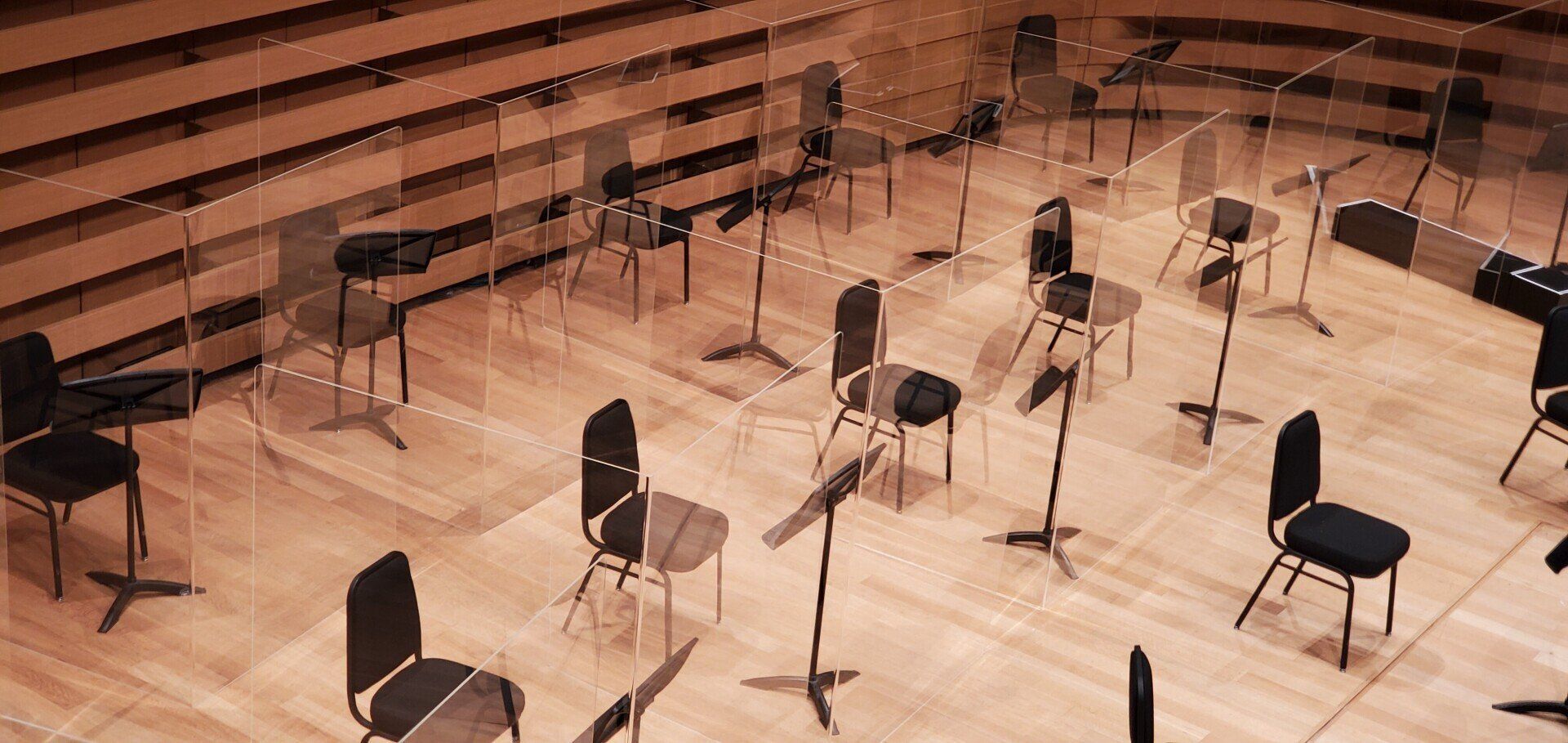 A large empty auditorium with a lot of chairs and instruments.